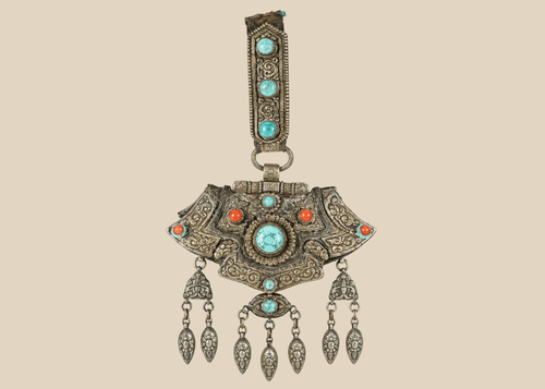 Antique Tibetan gau portable shrine pendant crafted from silvered copper alloy with turquoise and coral cabochons.