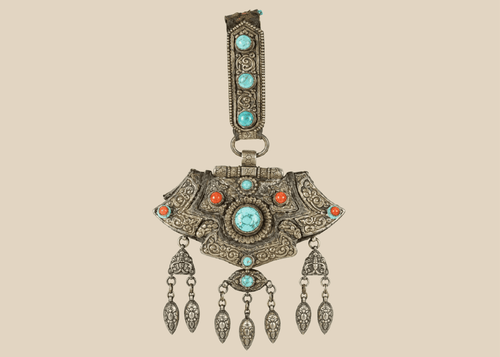 Antique Tibetan gau portable shrine pendant crafted from silvered copper alloy with turquoise and coral cabochons.