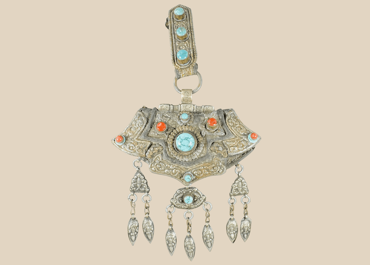 Antique Tibetan gau portable shrine pendant crafted from silvered copper alloy with turquoise and coral cabochons.