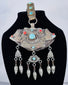 Historic Tibetan Buddhist portable shrine decorated with repoussé floral motifs and turquoise cabochons.