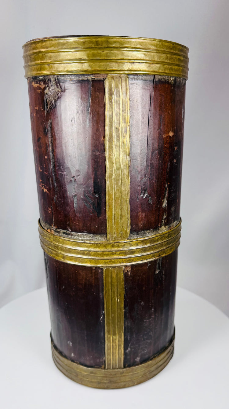 Himalayan hardwood storage jar displaying rich patina, hand-crafted brass fittings, and age-related wear.
