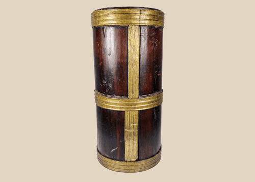 Antique Tibetan hardwood storage vessel with brass bands and traditional Himalayan coopered construction.
