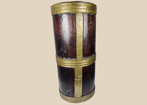 Antique Tibetan hardwood storage vessel with brass bands and traditional Himalayan coopered construction.