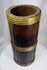 Traditional Tibetan grain container featuring dark hardwood staves and hand-worked brass reinforcements.