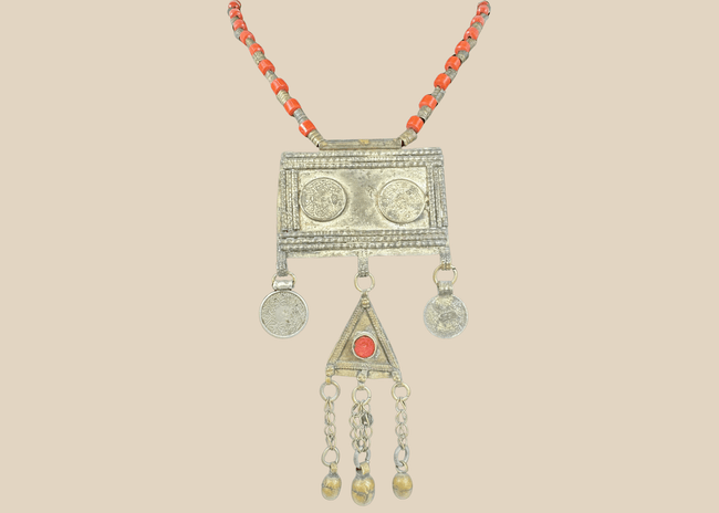 Antique Turkmen tribal necklace with a rectangular pectoral pendant, tumar amulet, and red glass beads.