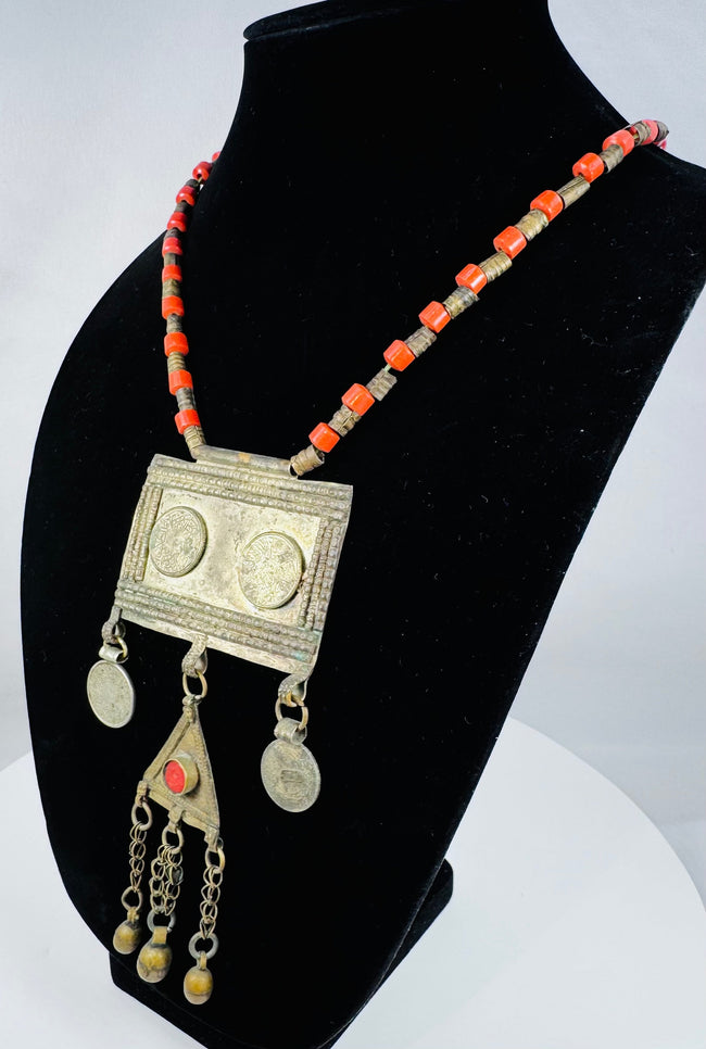 Traditional Turkmen necklace showcasing a large pectoral ornament, geometric decoration, and protective tumar amulet.