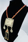 Traditional Turkmen necklace showcasing a large pectoral ornament, geometric decoration, and protective tumar amulet.