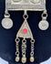 Ethnographic Turkmen necklace from Central Asia featuring silver-toned metal, red beads, and ceremonial tribal craftsmanship.