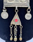 Ethnographic Turkmen necklace from Central Asia featuring silver-toned metal, red beads, and ceremonial tribal craftsmanship.
