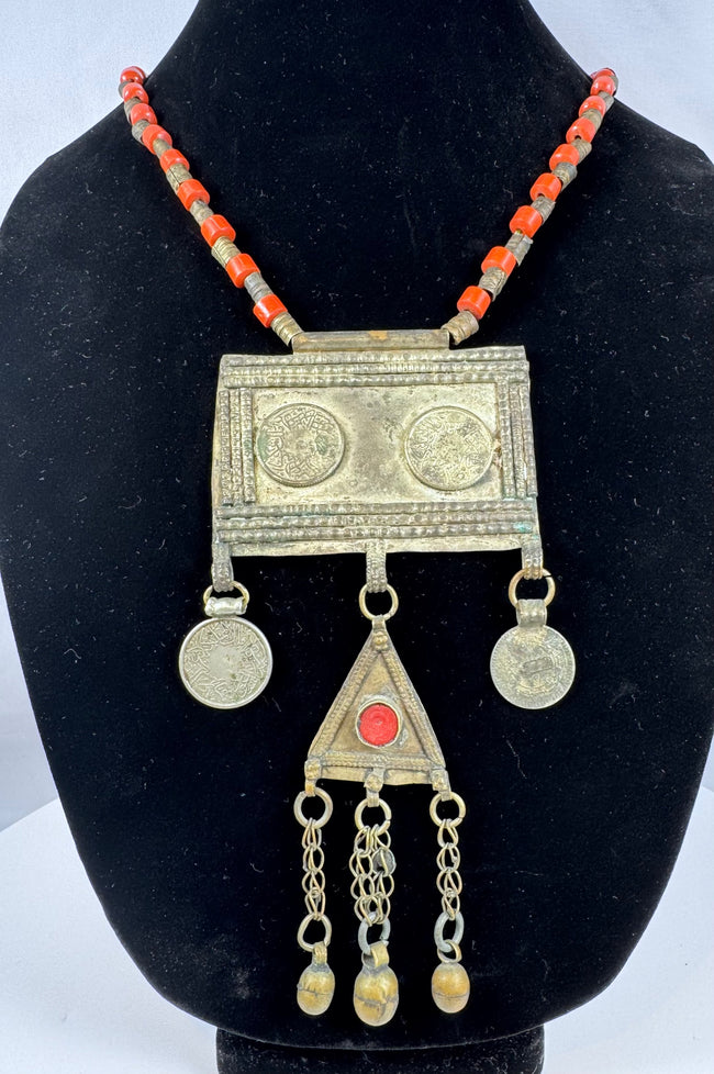 Central Asian Turkmen ceremonial necklace featuring silver-toned metal, coin pendants, and a triangular tumar pendant.