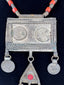 Late 19th-century Turkmen tribal necklace with Arabic coin motifs, red glass cabochon, and dangling chain ornaments.