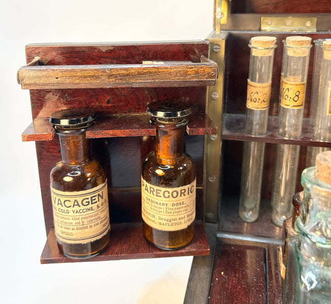 Close-up of Victorian apothecary bottles with paper labels and aged patina