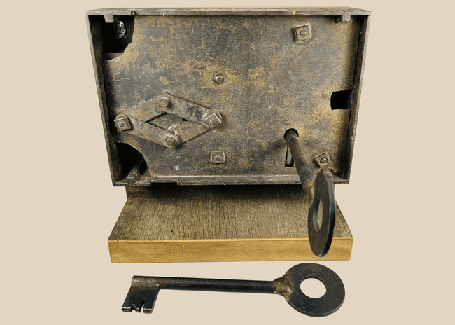 Antique 19th century iron rim lock with skeleton key on display