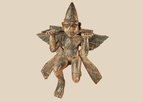 Antique hand-carved wooden winged temple guardian figure on display against a white background.