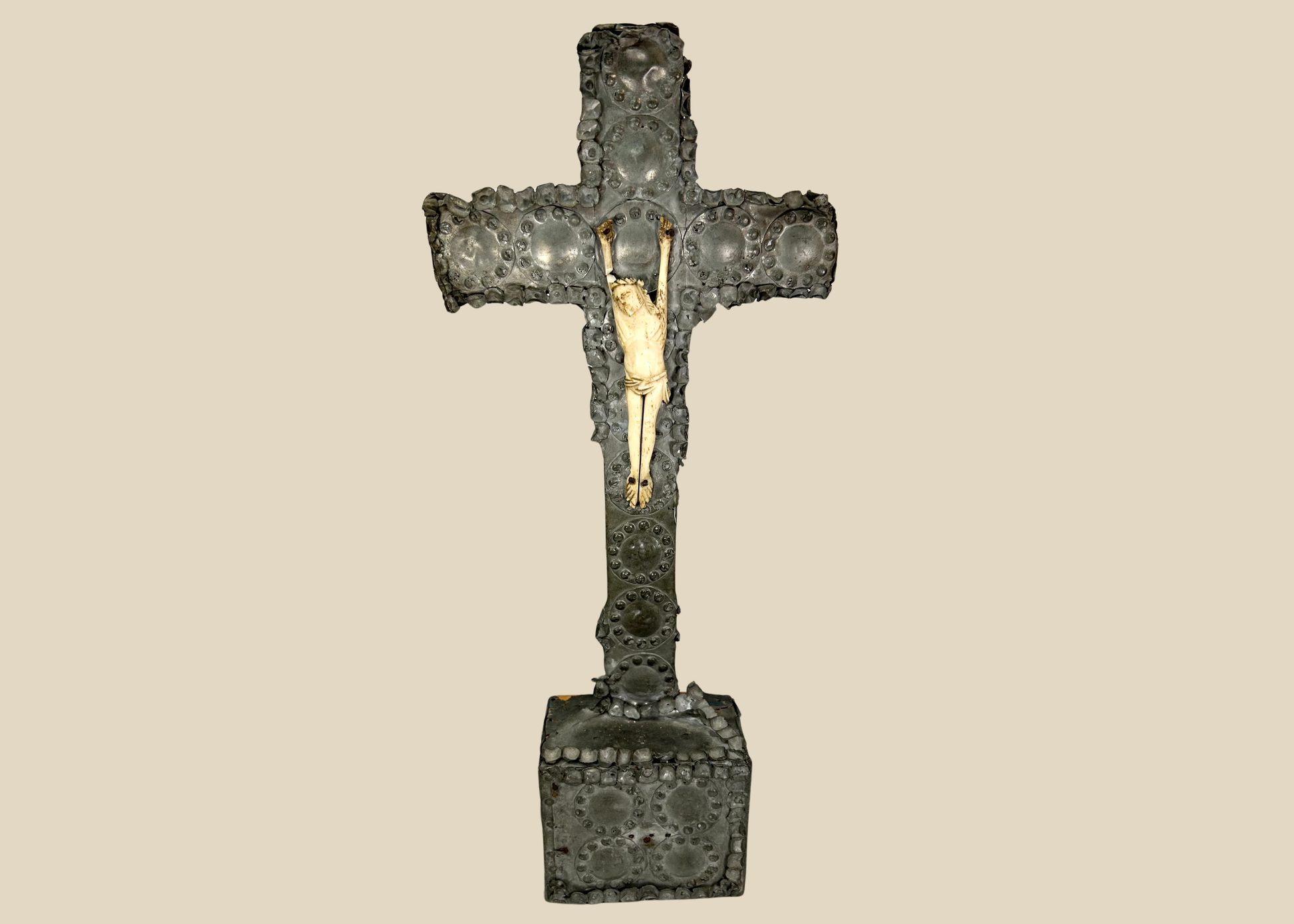 Antique crucifix — direct frontal view highlighting detailed casting and aged patina.