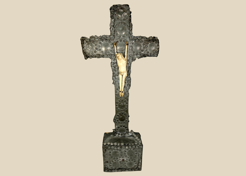 Antique crucifix — direct frontal view highlighting detailed casting and aged patina.