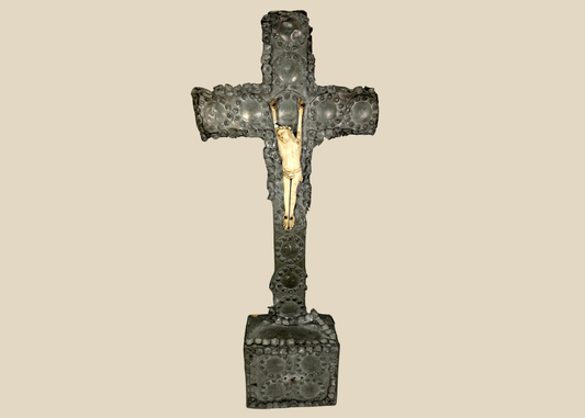 Antique crucifix — direct frontal view highlighting detailed casting and aged patina.