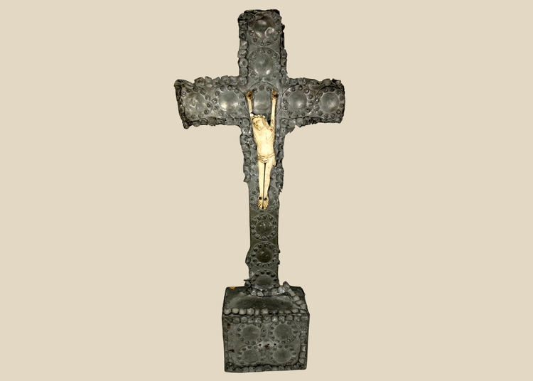 Antique crucifix — direct frontal view highlighting detailed casting and aged patina.