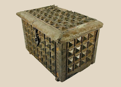 Late 19th-century Indian lidded box made of hardwood with brass cladding, featuring embossed geometric and pyramid-like designs. Original lock and latch intact. Combines traditional Indian craftsmanship, functional storage, and decorative elegance.