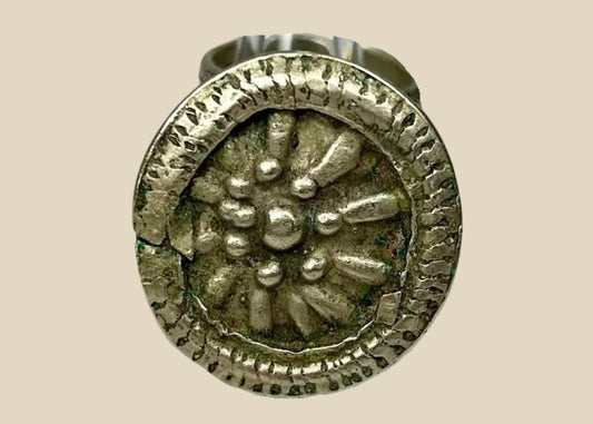 Late 19th century European silver-toned ring with raised rosette floral motif, beaded border, and tapered band, antique Victorian-era jewelry piece