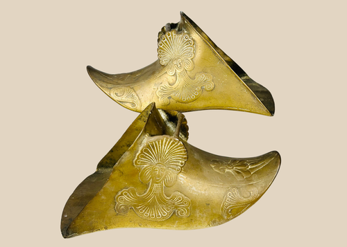 Pair of antique brass Spanish Colonial slipper stirrups with ornate figural relief decoration.