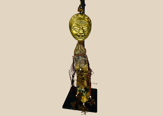 Tibetan gilt bronze guardian mask pendant with silk tassels and beads