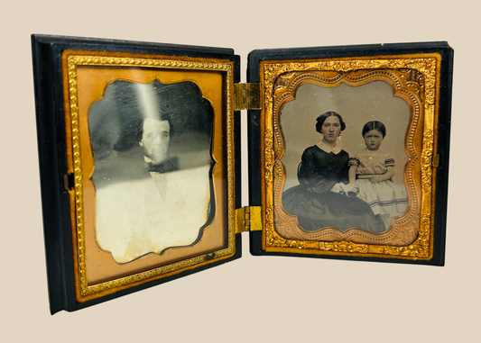 Antique Victorian daguerreotype case opened to reveal two 19th-century portraits