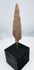 Broad tanged iron weapon point with heavy oxidation and mineral encrustation