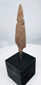 Broad tanged iron weapon point with heavy oxidation and mineral encrustation