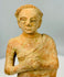 Vintage terracotta folk art figure with weathered finish