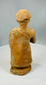 Folk-style terracotta sculpture with cap-like headdress
