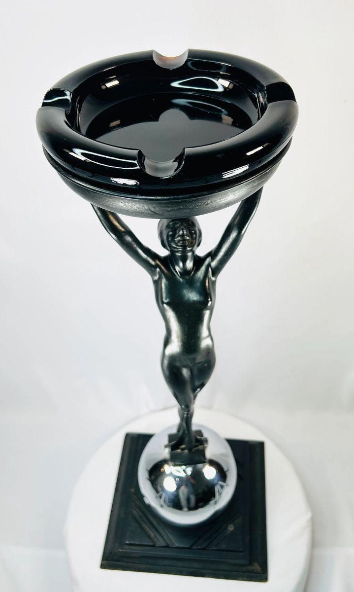 Rare Art Deco smoking stand, circa 1925–1935, attributed to Frankart Inc. New York. Features nude female figure with raised arms supporting circular tray, original patinated finish, and stepped Deco base. Iconic Jazz Age decorative design.