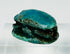 Three-quarter angled view of ancient Egyptian scarab with vivid blue-green glaze patina