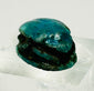 Close-up of New Kingdom Egyptian scarab showing detailed beetle carving and glaze wear