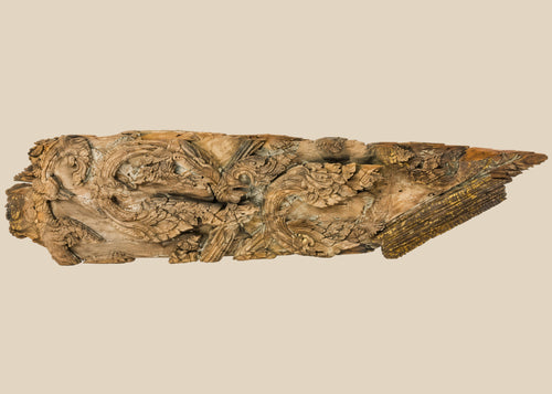 17th-century Thai Ayutthaya carved wooden temple fragment with flowing motifs, remnants of gilding, and symmetrical sacred design.
