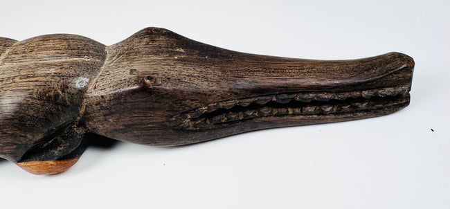 Carved wooden crocodile with articulated jaw and surviving inserted tooth pegs