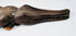 Carved wooden crocodile with articulated jaw and surviving inserted tooth pegs