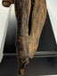 17th-century wooden Christ figure with expressive facial features and pronounced ribcage