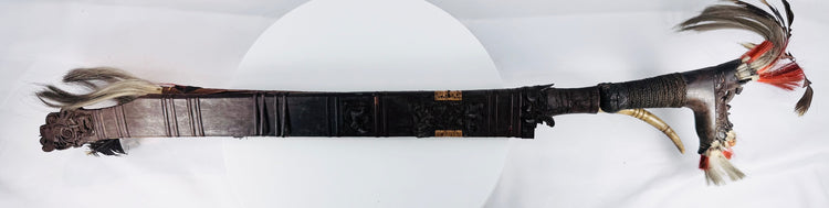Early 20th-century Dayak sword with hand-forged blade and decorated scabbard