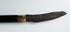 Mandau sword displayed beside its carved scabbard and attached pisau raut