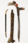 Borneo Mandau sword ensemble with feathered hilt, carved sheath, and side knife
