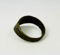 Close-up of engraved motifs on brass thumb ring