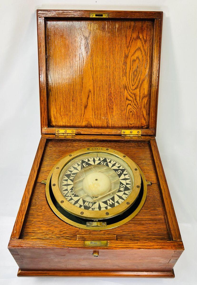Antique brass ship compass by E.S. Ritchie, mounted in a fitted wooden case, originating from a Canadian political estate; nautical navigation instrument with original glass face, engraved directional markers, and aged patina, representing 19th–20th century maritime craftsmanship and provenance-linked historical significance.