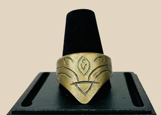 Brass archer’s thumb ring on black display stand