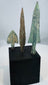 Small barbed bronze arrowhead with swallow-like wings and central tang