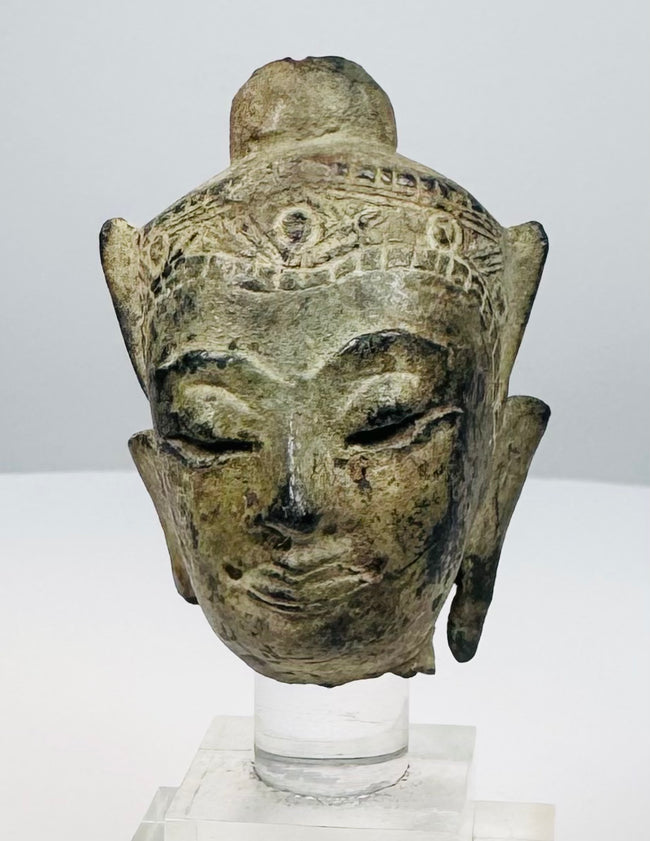 15th–18th century Southeast Asian bronze Buddha head with green-brown patina and traces of gilt