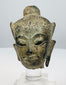 15th–18th century Southeast Asian bronze Buddha head with green-brown patina and traces of gilt