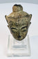 Historic crowned Buddha head with arched brows, closed eyes, subtle smile, and ornate crown band