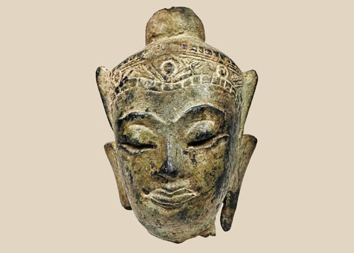 Fragmentary cast bronze Buddha head with serene expression, arched brows, closed eyes, subtle smile, and engraved crown band; traces of gilt and lacquer; likely Thailand or Burma, Late Ayutthaya–Early Rattanakosin or Toungoo–Konbaung period, circa 15th–18th century CE; mounted on a custom acrylic stand.
