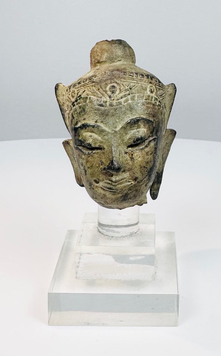 Southeast Asian bronze Buddha fragment with meditative features, aged patina, and lacquer traces